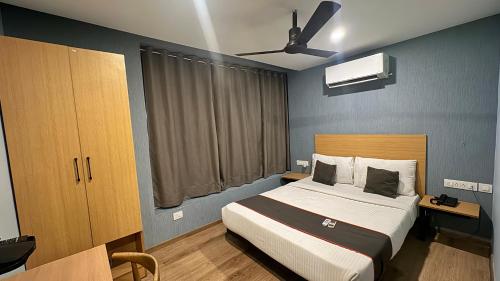 a bedroom with a bed and a ceiling fan at PHP BOUTIQUE TOWNHOUSE in Chennai
