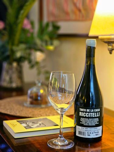 a bottle of wine and a glass on a table at BE Jardin Escondido By Coppola in Buenos Aires