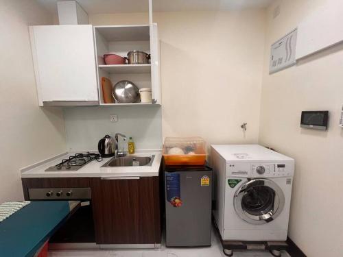 a small kitchen with a sink and a washing machine at Ideal Budget and Cozy Private Studio with Amazing Pool by SYM C738 in Phnom Penh