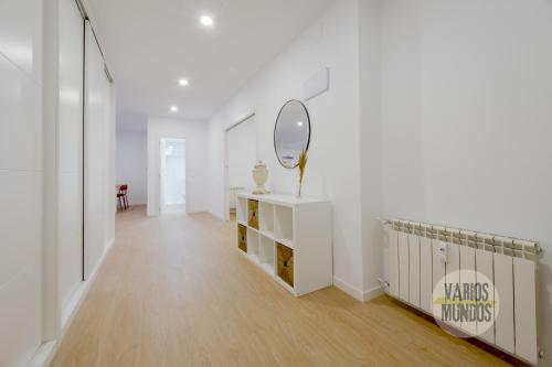 a white hallway with a mirror and a dressing table at Smart Apartment 3pax en Madrid Rio con Parking in Madrid