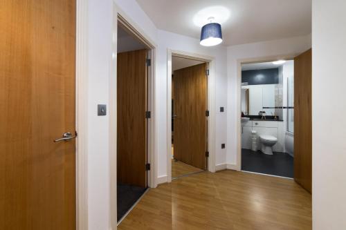 a hallway with a bathroom and a toilet at Cutlass Court Apartments by Comfort Zone in Birmingham