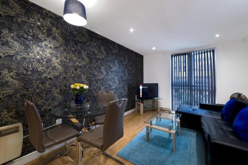 a living room with a table and a couch at Cutlass Court Apartments by Comfort Zone in Birmingham