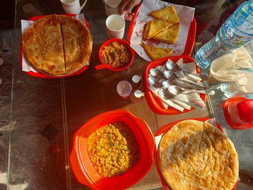 a table topped with plates of food and pies at RED ROSE HOTEL & RESORT Mansehra in Mānsehra