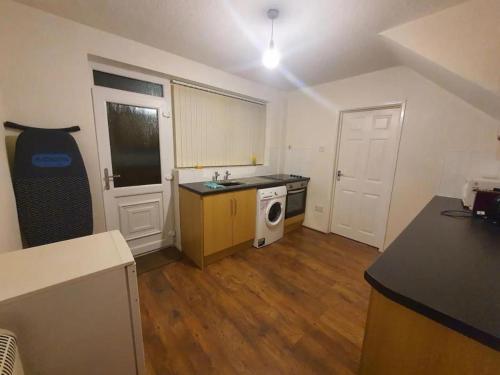 a small kitchen with a sink and a stove at Double Bedroom TDA Greater Manchester in Middleton