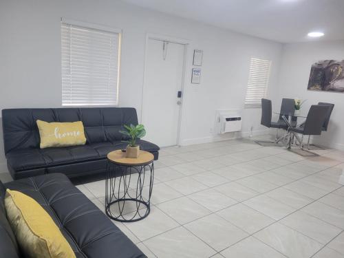 a living room with a couch and a table at Arpe 4plex in Fort Lauderdale