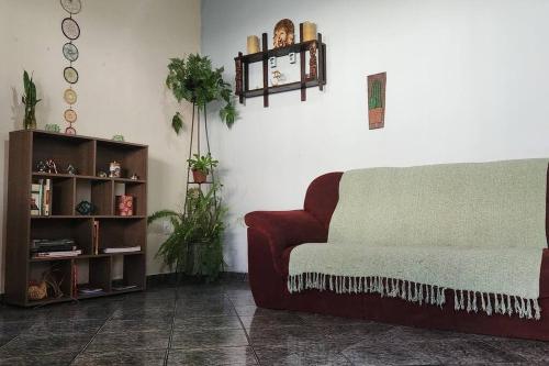 a living room with a couch and a shelf at Casa Dhamma in São João del Rei