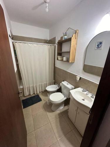 a bathroom with a toilet and a sink at Departamento en planta baja con cochera in Salta