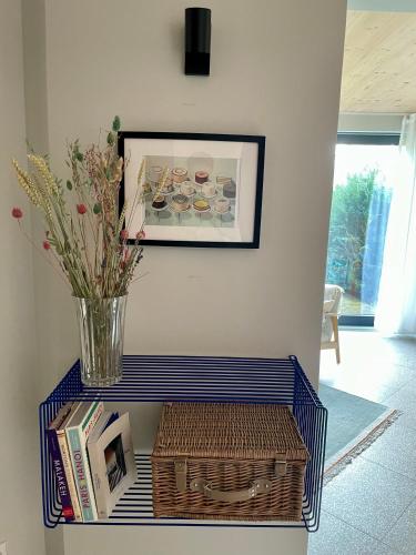 a table with a vase and a basket on it at Traumhaftes Ferienhaus am See am Lübbesee in Templin in Templin