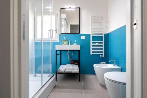 a blue and white bathroom with a tub and a sink at Appartamenti vista mare Otranto in Otranto
