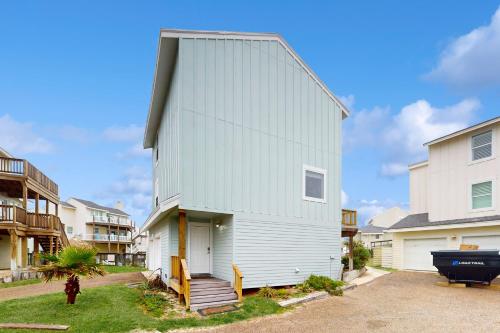 a white house with a gambrel roof at Lost Colony IV in Port Aransas
