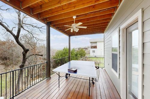 a balcony with a table and a ceiling fan at Point Venture Lookout in Lago Vista