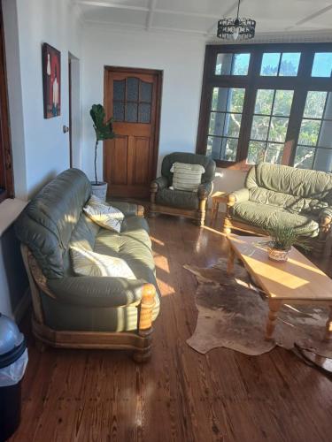 a living room with two couches and a coffee table at CasaMia in Bredasdorp