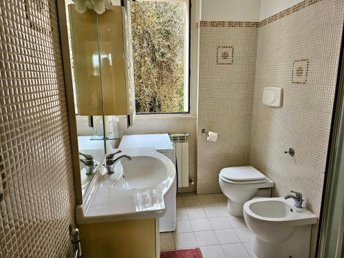 bagno con lavandino, servizi igienici e finestra di SE052 - Marotta, delizioso bilocale con giardino a Marotta