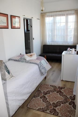 a bedroom with a bed and a living room at CasaMia in Bredasdorp
