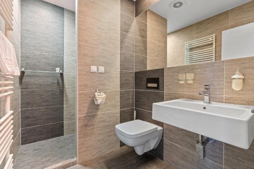 a bathroom with a toilet and a sink at Vila Jiřinka in Luhačovice