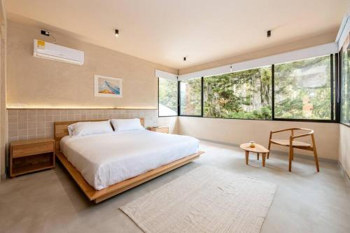 a bedroom with a bed and a large window at Casa Penta Top Notch Villa in Medellín