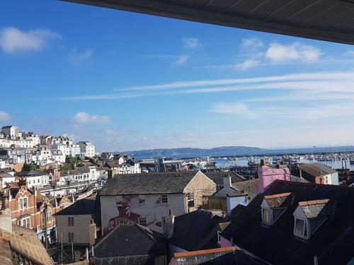 a view of a city with houses and buildings at Stunning Penthouse views to harbour with parking. in Brixham
