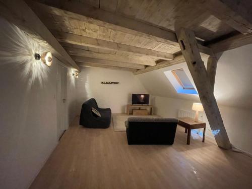 a living room with a couch and a table at La grange de Sophie in Berstett