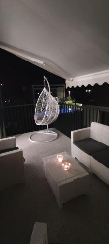 a living room with a couch and a table at Apartament Glamour 10B- Premium z basenem in Łukęcin