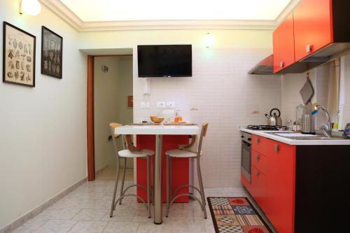 a kitchen with red cabinets and a white counter top at BoHome in Chieti