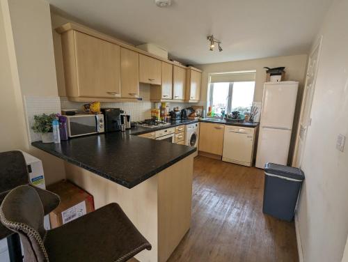 a kitchen with a counter and a refrigerator at Double rooms in Milton