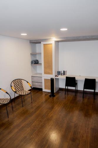 a room with chairs and a table in a room at Hotel Piedras De Maní in Manizales