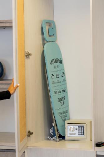 a surfboard is on a shelf in a room at Hotel Piedras De Maní in Manizales