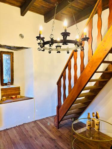 a dining room with a staircase and a glass table at FOPPOLI CASTLE, PRIVATE 11th CENTURY FORTRESS WITH PANORAMIC VIEW, SAUNA AND HOT TUB OVERLOOKING THE VALTELLINA in Mazzo di Valtellina