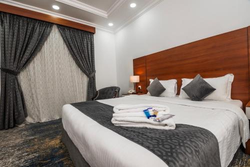 a hotel room with a bed with towels on it at فندق انوار - Anwar Hotel in Al Madinah
