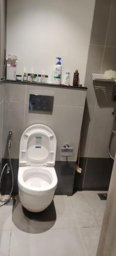 a bathroom with a white toilet in a stall at Fully Furnished one BHK Studio Apartment, at Sohna Road, Gurugram in Gurgaon