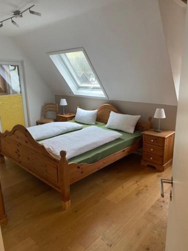 a bedroom with a bed with a window on it at Artgerecht Naturverliebt in Bad Berleburg