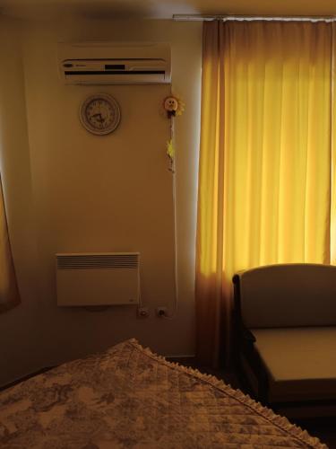 a bedroom with a bed and a window and a chair at Rutland Bay in Ravda