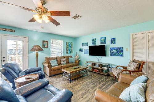 a living room with couches and a flat screen tv at Dock and Bay Access Rockport Home on Canal in Rockport