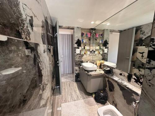 a dirty bathroom with a sink and a toilet at House of Luxury 8 in Mumbai
