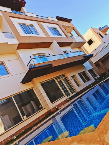 a building with a swimming pool in front of it at Grand Room in Sheikh Zayed