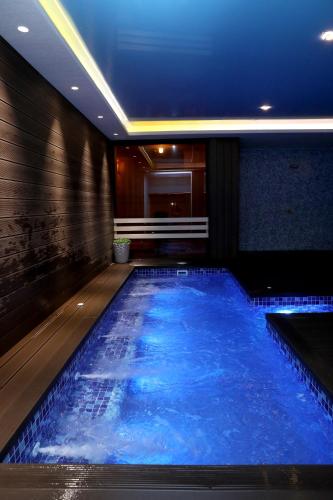 a swimming pool in a hotel with blue water at Best Western Plus Paradise Hotel Dilijan in Dilijan