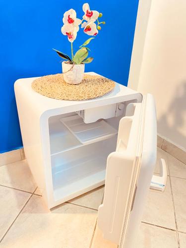 a white table with a plant on top of it at Blu Airport Room Fiumicino in Fiumicino