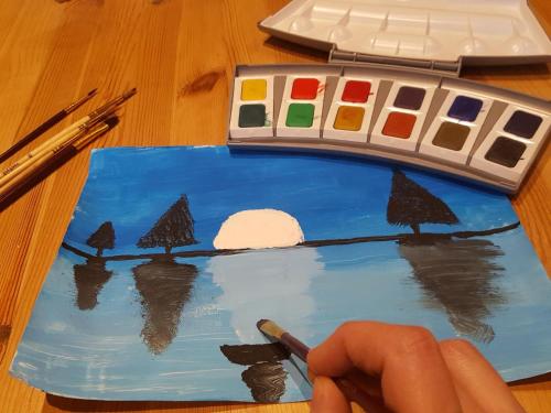 a personpainting a picture of trees on a painting at Susque8 in Izel