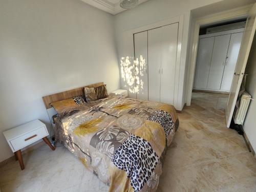 a bedroom with a bed with a cheetah blanket at Gouletteparadis in La Goulette