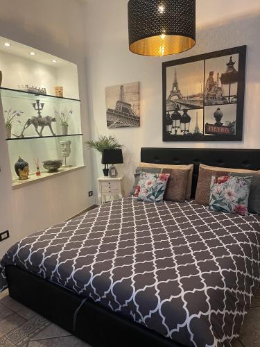 a bedroom with a bed with a black and white comforter at Fashion Loft Luxury Milano in Milan