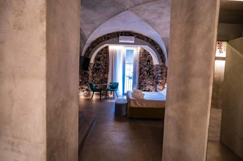 a bedroom with a bed in a room with an archway at CHARME Catania Central Suites in Catania