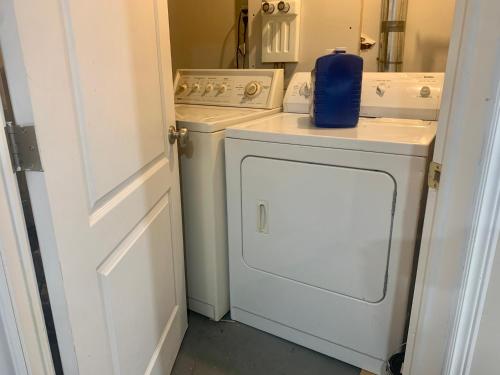 a white washer and dryer in a small kitchen at 2 bedroom basement with private side entrance in Guelph