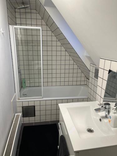 a bathroom with a sink and a mirror at Loft Apartment in Central Zug in Zug