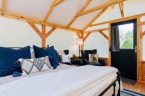 a bedroom with a bed with blue and white pillows at The Preserve Battenkill River in Cambridge