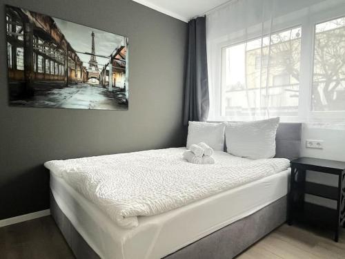 Un dormitorio con una cama con un osito de peluche. en Staywell for 4 in the City I Parking I WiFi I Netflix, en Paderborn