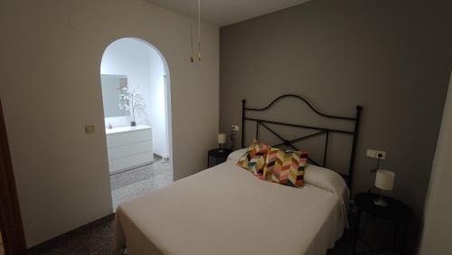 a bedroom with a bed and an arched doorway at Apartamento VILLASOLETE in Fuengirola