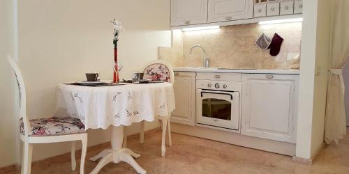 a kitchen with a table and chairs and a sink at Apartments on Kirova in Dnipro