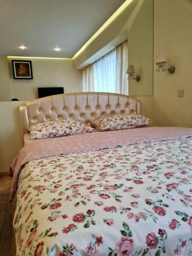 1 dormitorio con 1 cama grande con colcha de flores en Apartments on Kirova en Dnipró