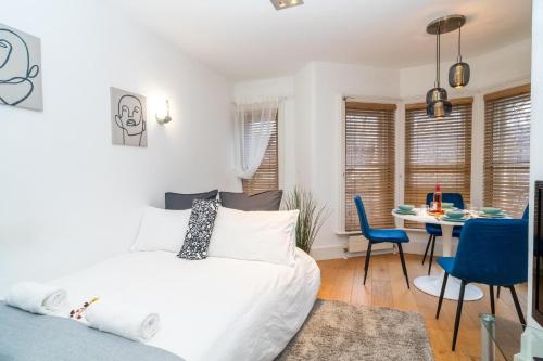 a bedroom with a bed and a table and chairs at Heart of London's West End / Pro Host in London