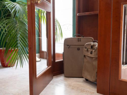a suitcase sitting in a hallway next to a door at Hotel SAN PIO in San Giovanni Rotondo